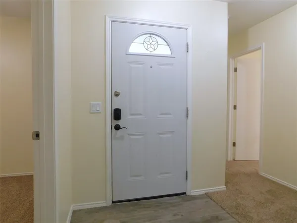 a view of front door with washer and dryer