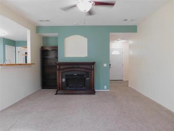 a view of empty room with a fireplace
