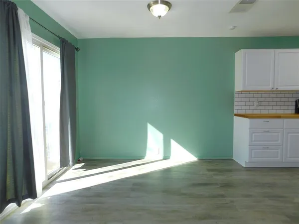 a view of a kitchen cabinets and a wooden floor