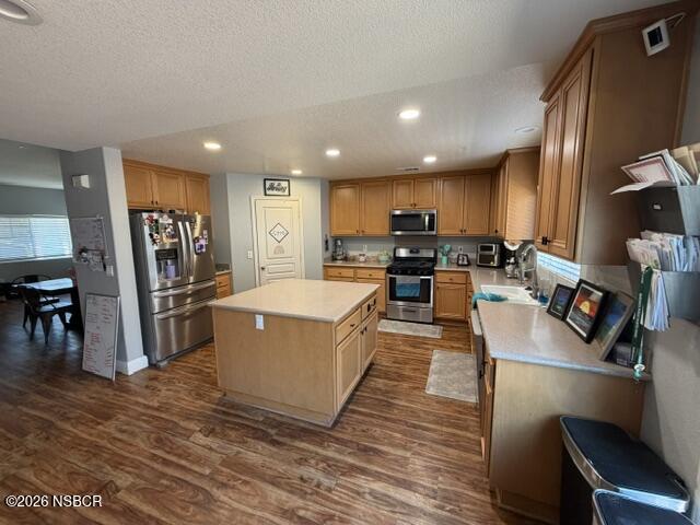 1114 Point Sal Loop Lompoc, CA 93436 - Photo 7 of 25 a kitchen with stainless steel appliances granite countertop a refrigerator oven a sink dishwasher and a dining table with wooden floor