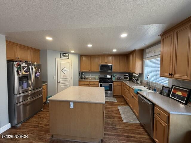 1114 Point Sal Loop Lompoc, CA 93436 - Photo 8 of 25 a kitchen with stainless steel appliances kitchen island granite countertop a refrigerator a stove a sink and a microwave