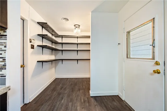 a view of walk in closet with empty racks