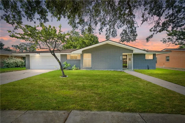 a house that has a tree in front of it