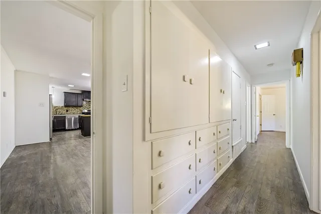 a view of a kitchen with wooden cabinet