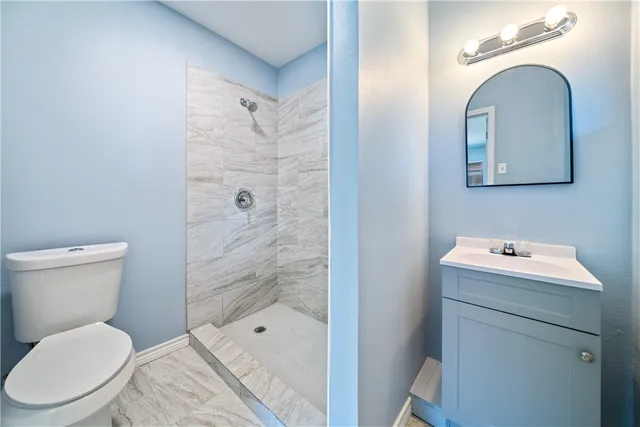 a bathroom with a toilet sink and shower