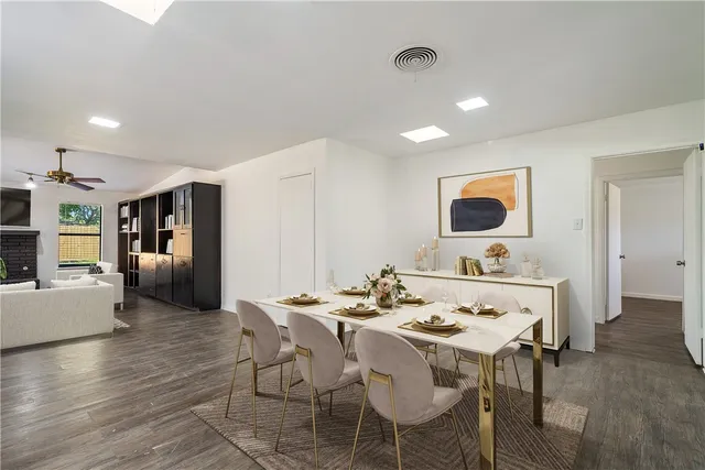 a dining room with furniture and wooden floor
