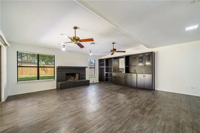 wooden floor in an empty room with a fireplace