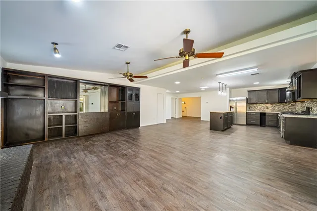 a view of kitchen with furniture and refrigerator