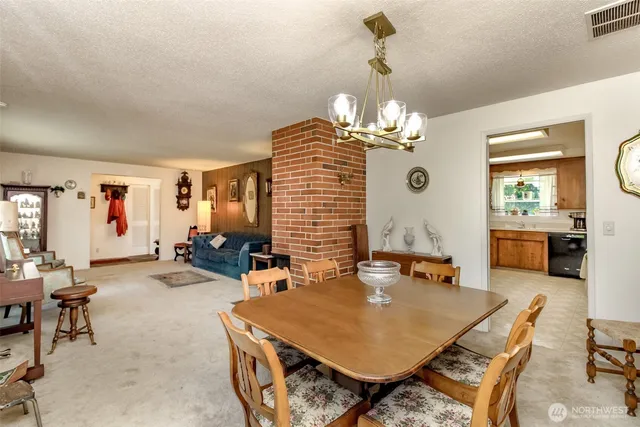 a view of a dining room with furniture and a chandelier