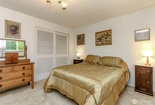 a bedroom with a bed and a night stand