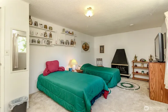 a bedroom with two beds and painting on the wall