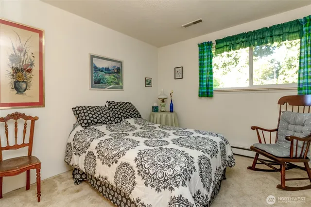 a bedroom with a bed and chair