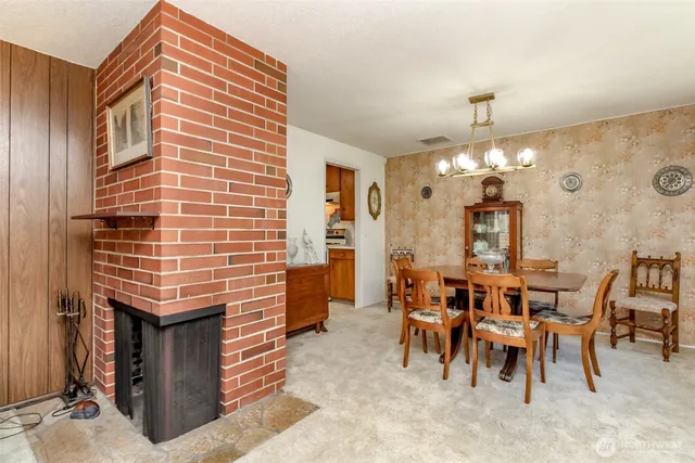 a dining room with a wooden table and chairs