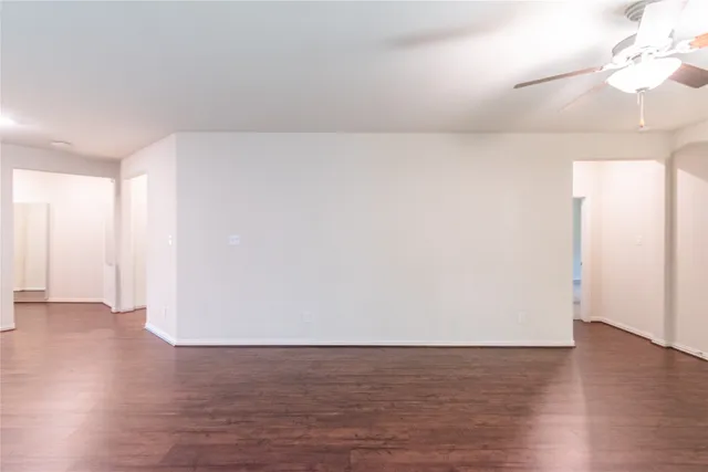 a view of an empty room and wooden floor
