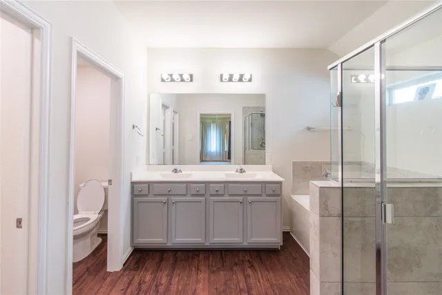 a bathroom with a granite countertop sink a mirror and a shower