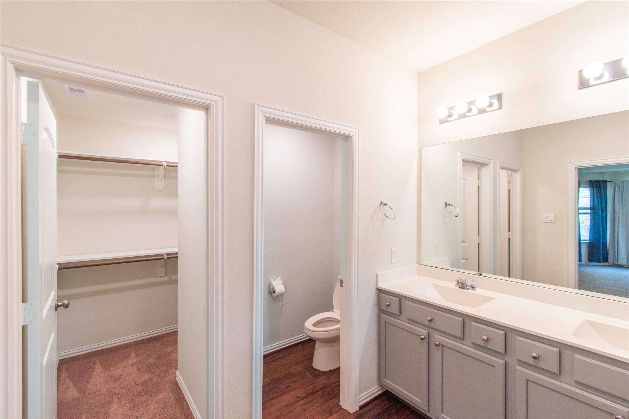 4639 Sequoia Echo Drive Spring, TX 77386 - Photo 18 of 30 a bathroom with a granite countertop toilet a sink and a mirror