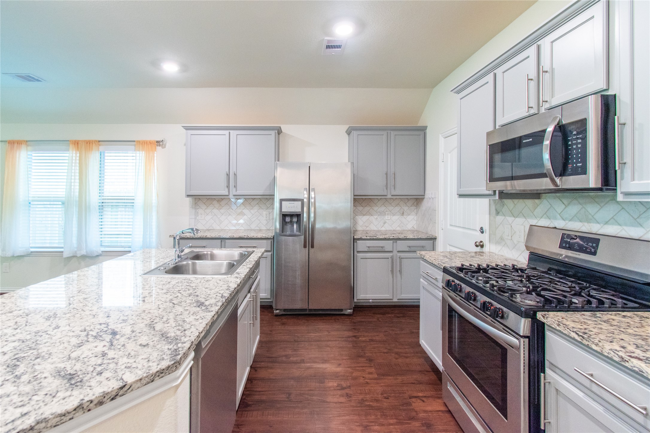 4639 Sequoia Echo Drive Spring, TX 77386 - Photo 5 of 30 a kitchen with stainless steel appliances granite countertop a stove a sink and a microwave