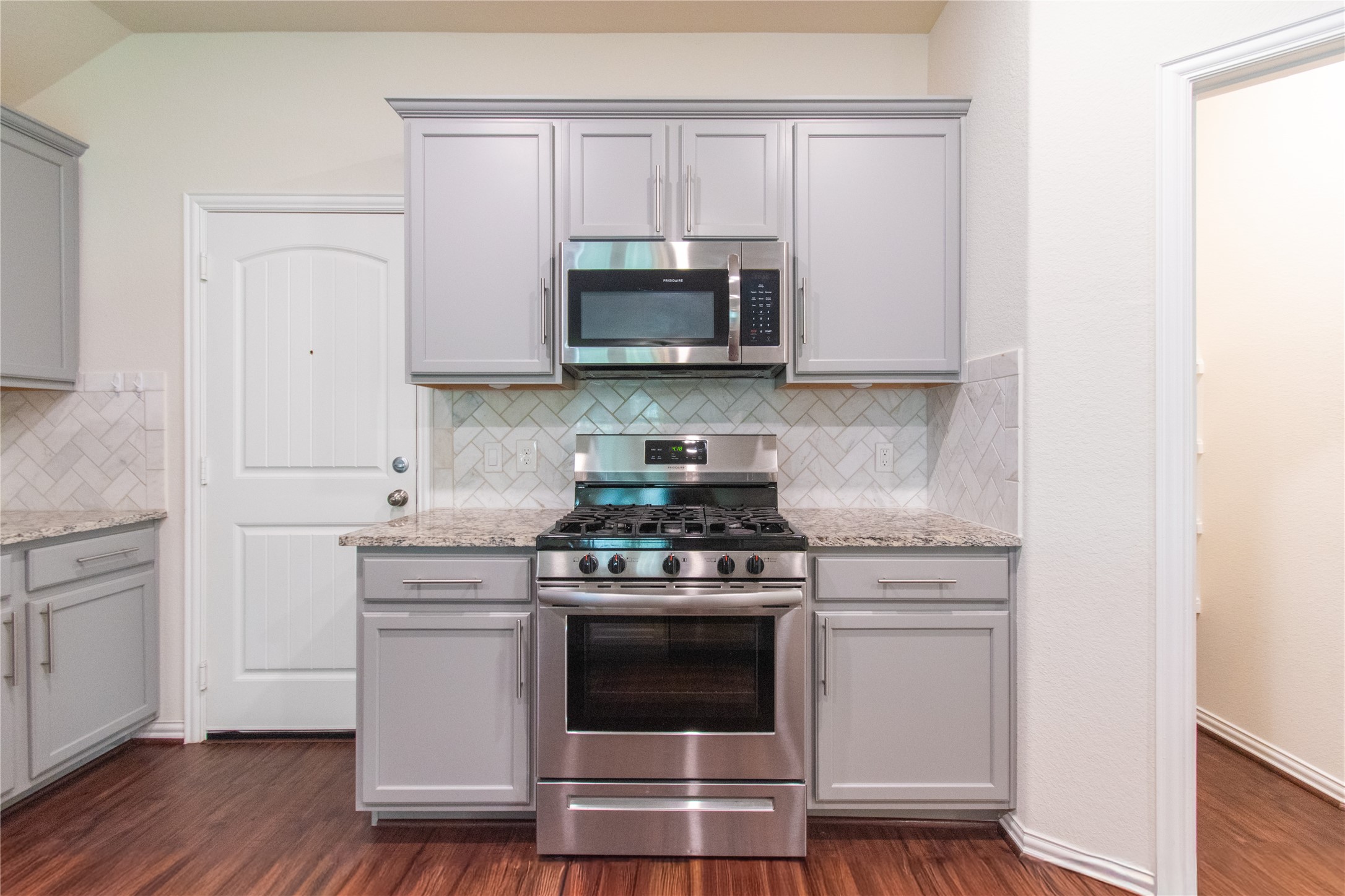 4639 Sequoia Echo Drive Spring, TX 77386 - Photo 6 of 30 a kitchen with white cabinets and stainless steel appliances