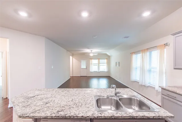 a kitchen with stainless steel appliances granite countertop a sink a stove and a granite counter tops