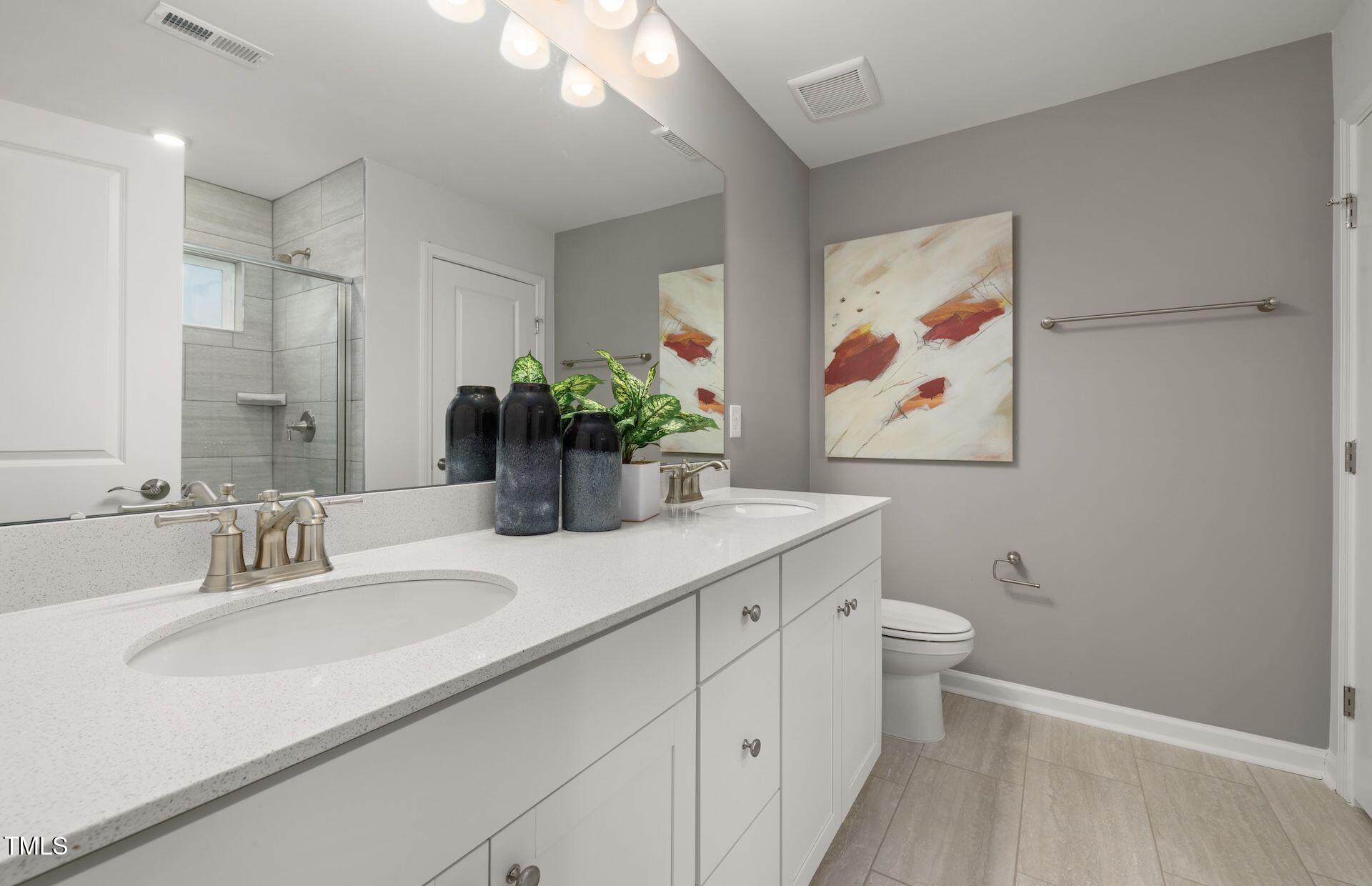 1017 Freestone Road Durham, NC 27703 - Photo 10 of 16 a bathroom with a sink a vanity and a large mirror