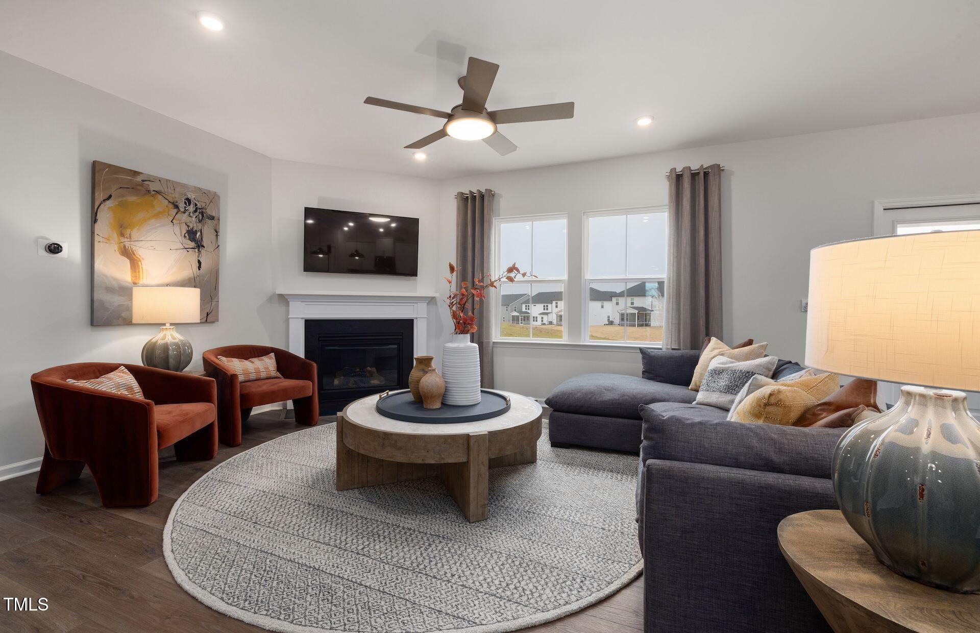 1017 Freestone Road Durham, NC 27703 - Photo 5 of 16 a living room with furniture a flat screen tv and a fireplace