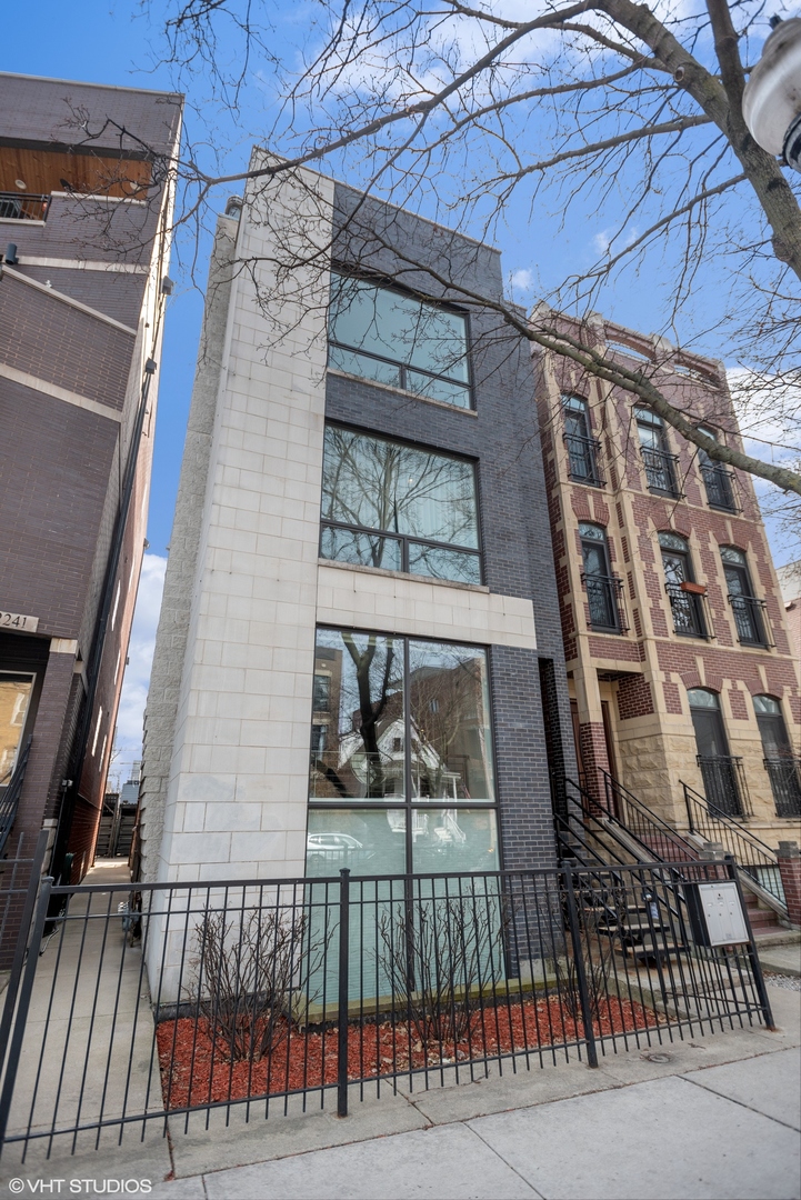 2243 West Roscoe Street, Unit 3 Chicago, IL 60618 - Photo 1 of 23 a view of a brick building with a door