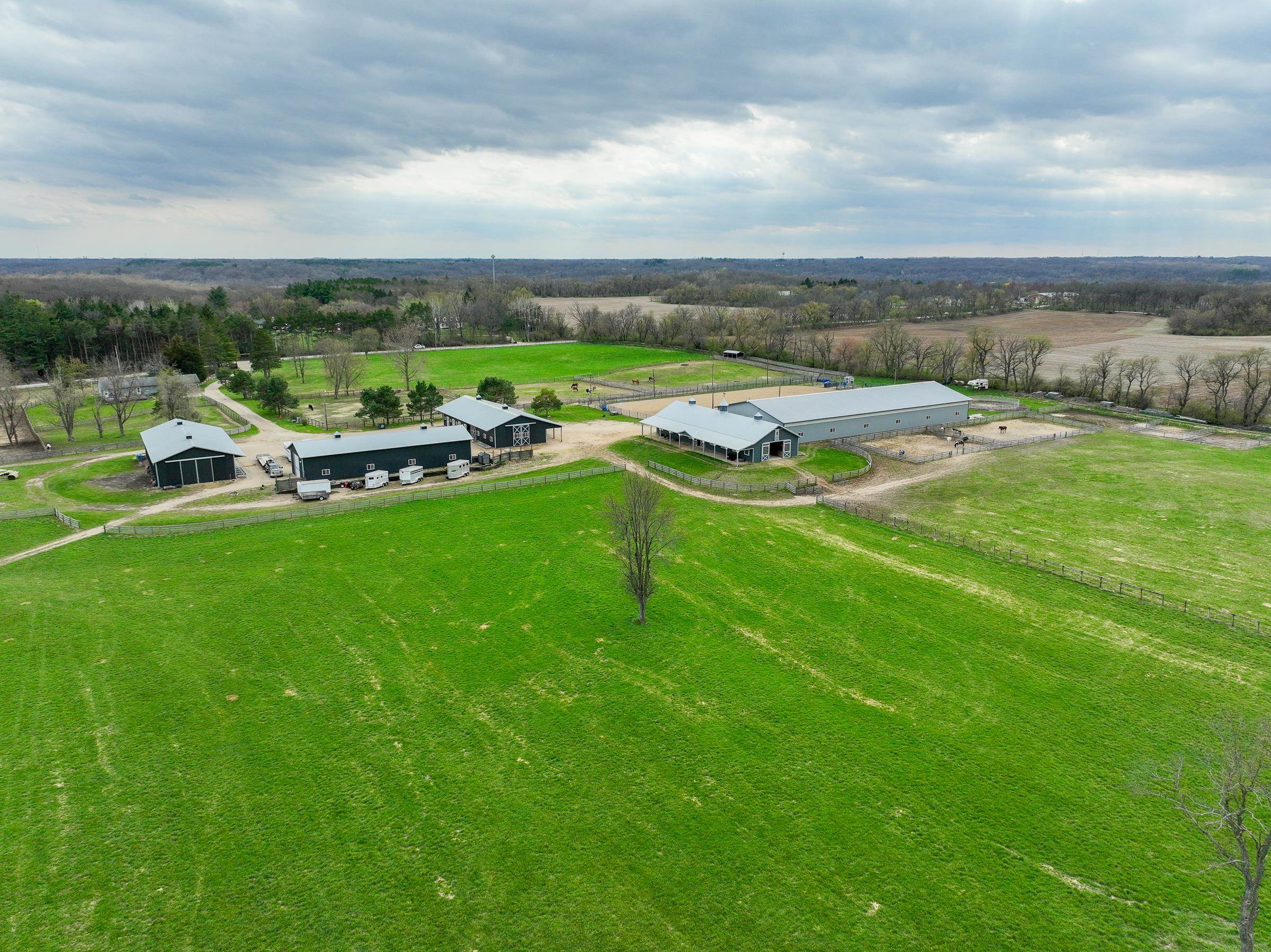 8206 Bull Valley Road Bull Valley, IL 60098 - Photo 16 of 24 a view of a lake with lawn chairs and large trees