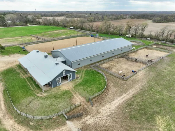 an aerial view of a house with a yard and lake view