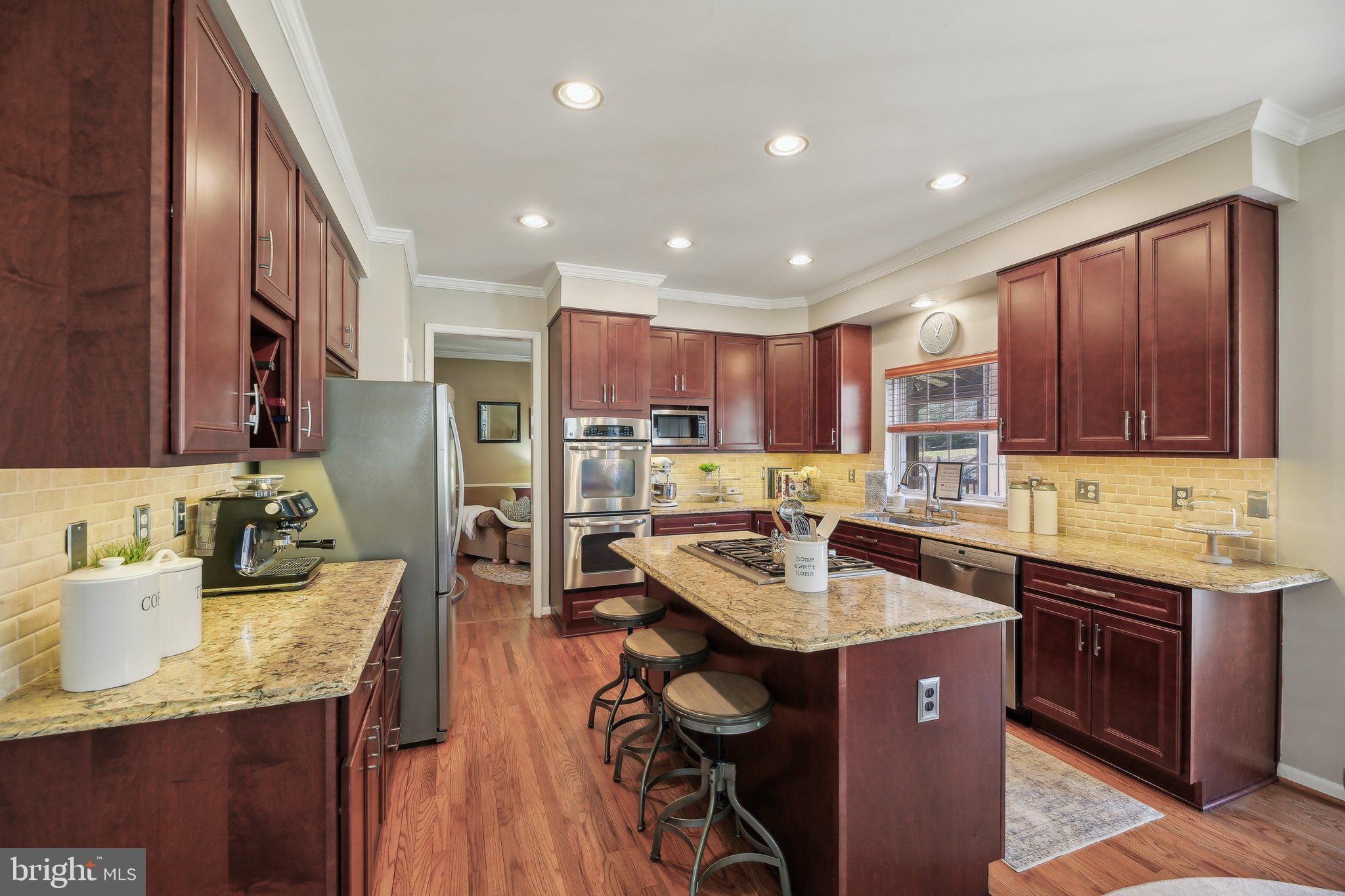 10204 Crosscut Way Damascus, MD 20872 - Photo 15 of 65 a kitchen with a sink a center island stainless steel appliances and cabinets