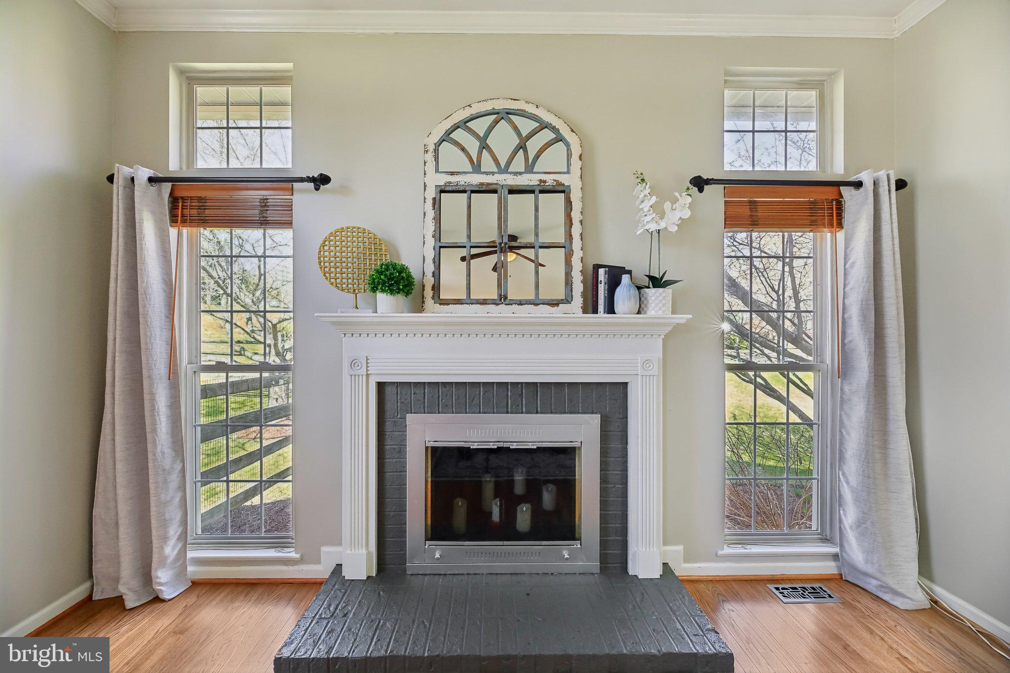 10204 Crosscut Way Damascus, MD 20872 - Photo 21 of 65 a living room with a fireplace and a window