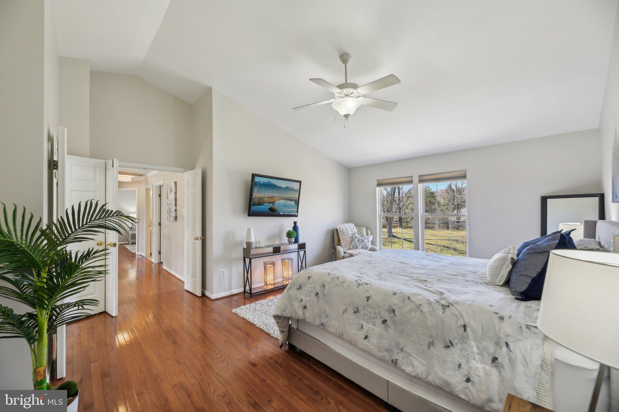 10204 Crosscut Way Damascus, MD 20872 - Photo 30 of 65 a bedroom with a bed and a chandelier