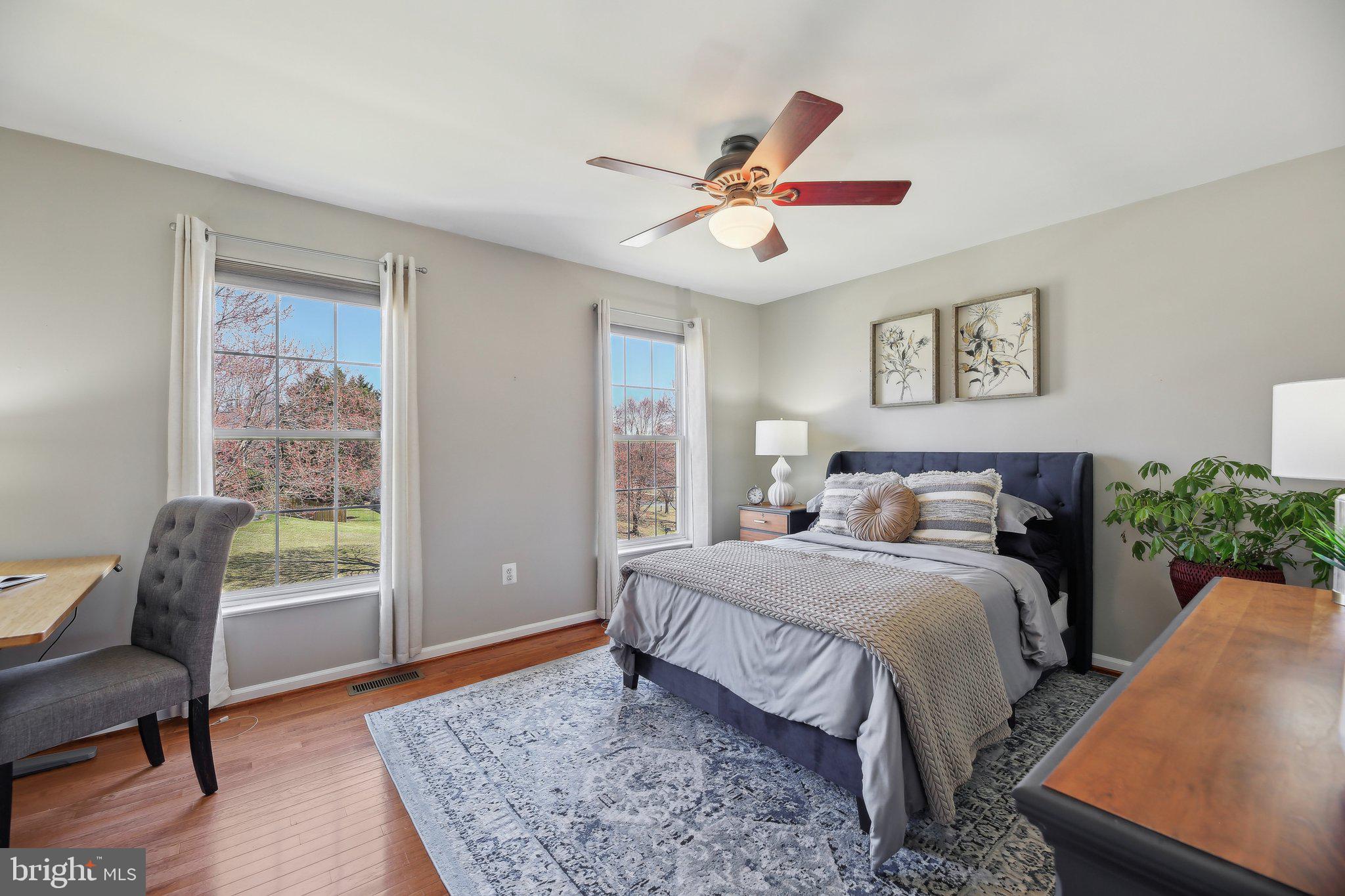 10204 Crosscut Way Damascus, MD 20872 - Photo 34 of 65 a bedroom with a bed and a chair