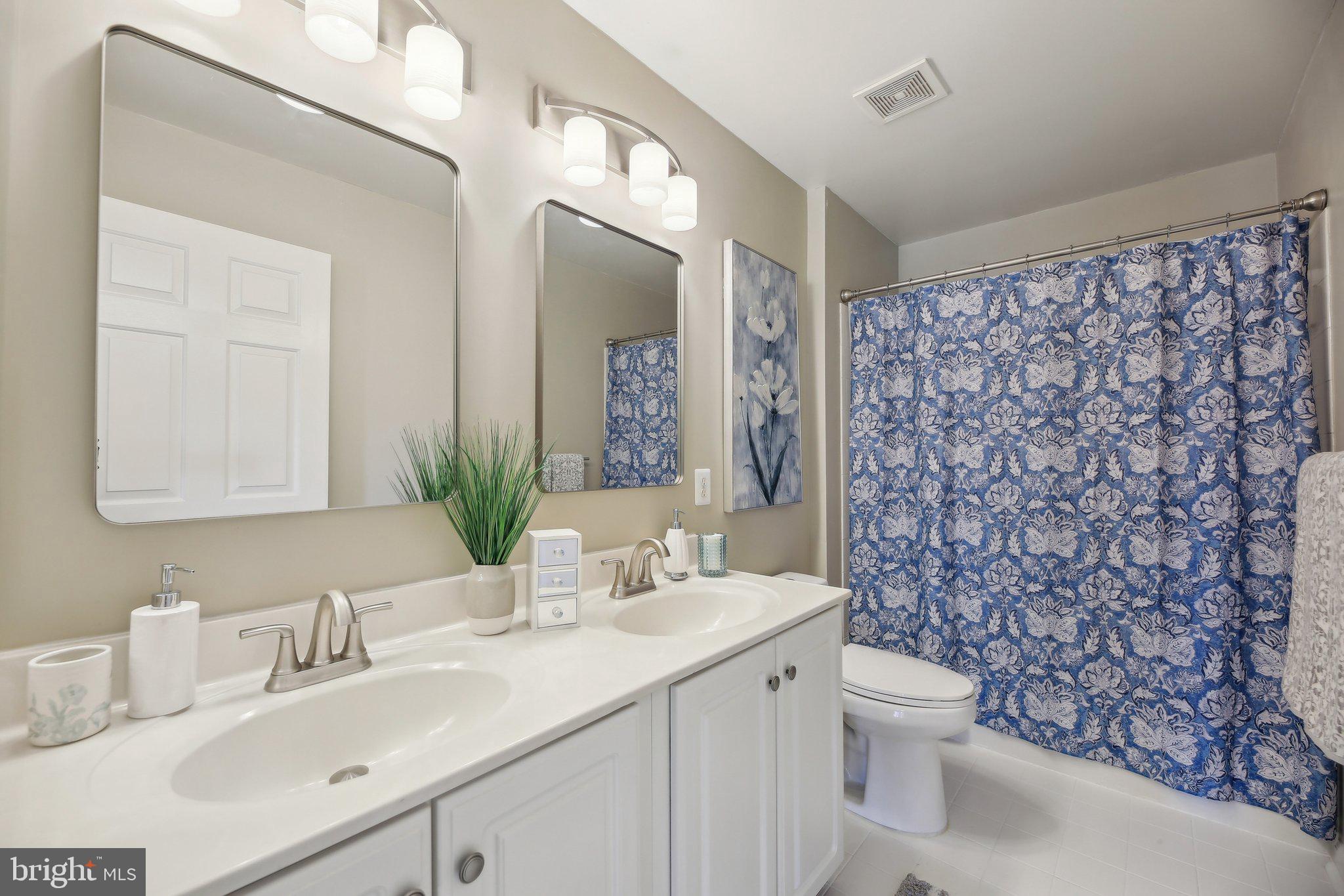 10204 Crosscut Way Damascus, MD 20872 - Photo 36 of 65 a bathroom with a sink vanity mirror and toilet