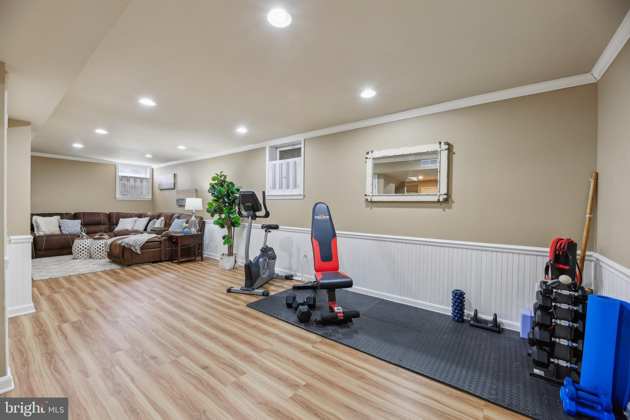 10204 Crosscut Way Damascus, MD 20872 - Photo 41 of 65 a living room with furniture and a wooden floor