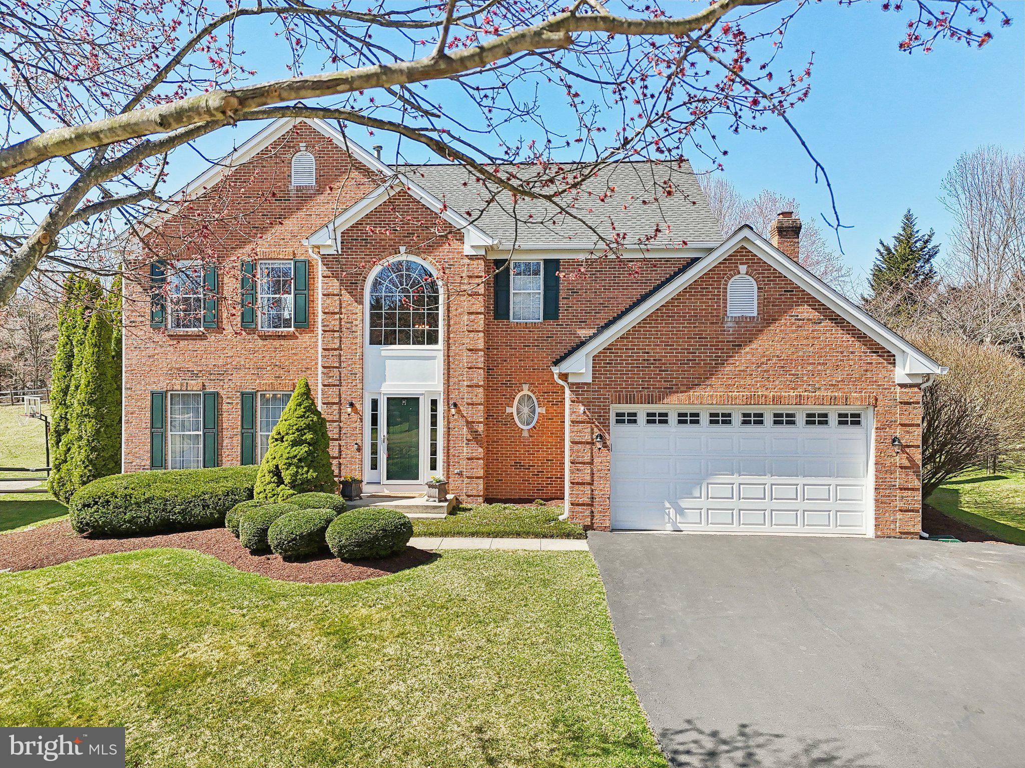 10204 Crosscut Way Damascus, MD 20872 - Photo 52 of 65 a front view of a house with a yard and garage