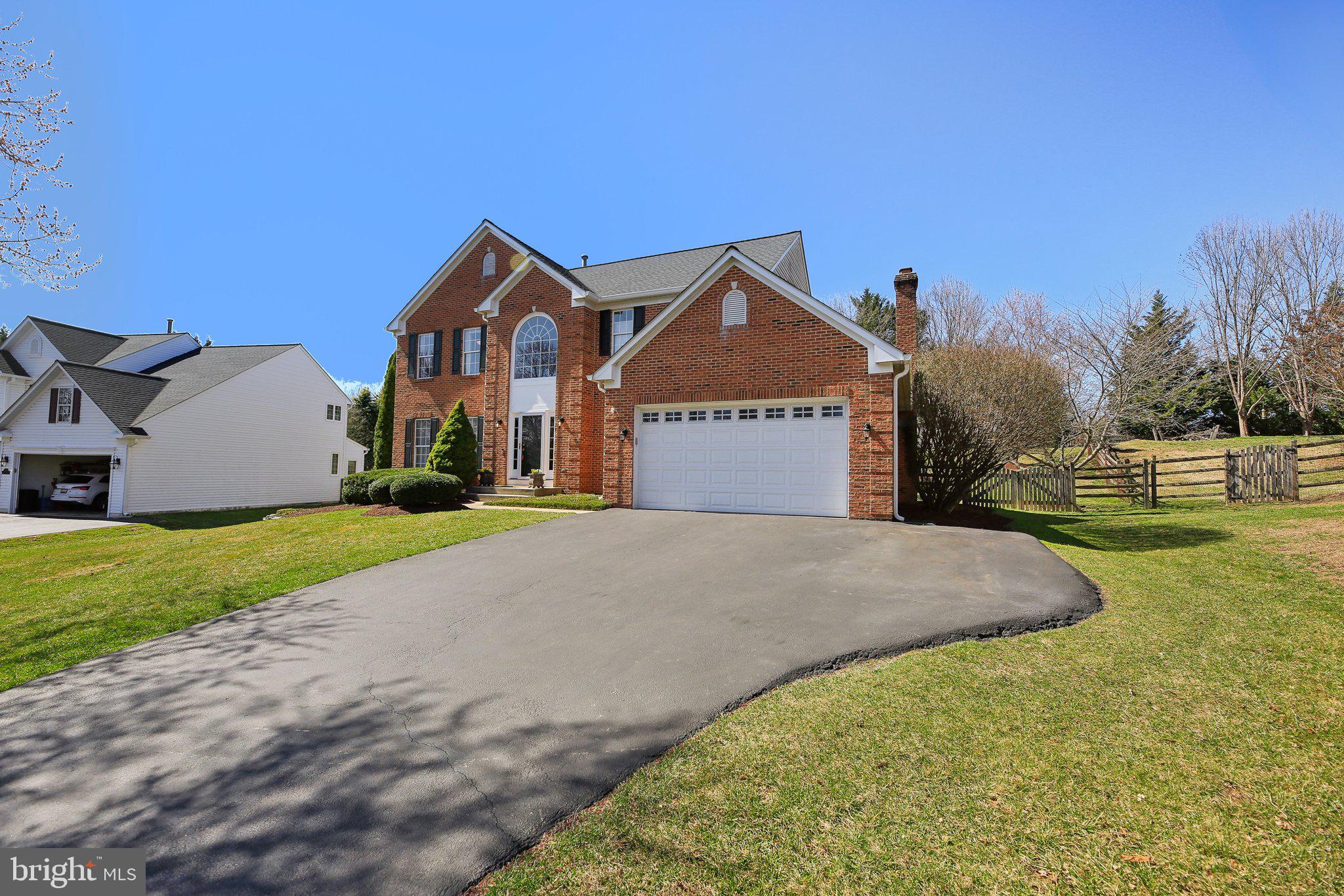 10204 Crosscut Way Damascus, MD 20872 - Photo 6 of 65 a front view of a house with a yard and garage