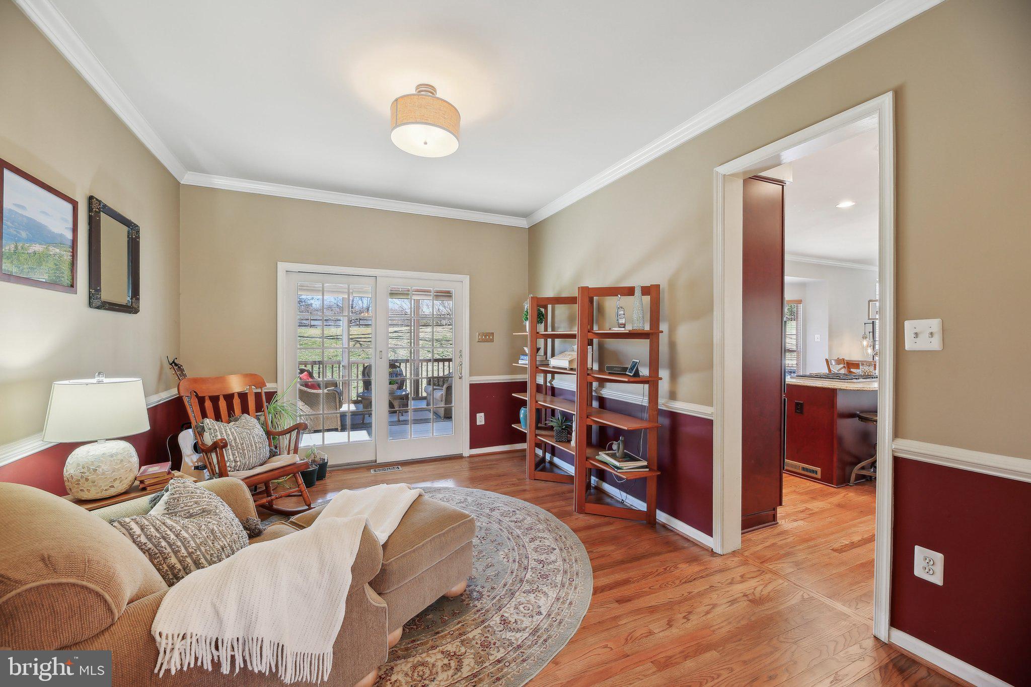 10204 Crosscut Way Damascus, MD 20872 - Photo 9 of 65 a living room with furniture or couch and a bookshelf