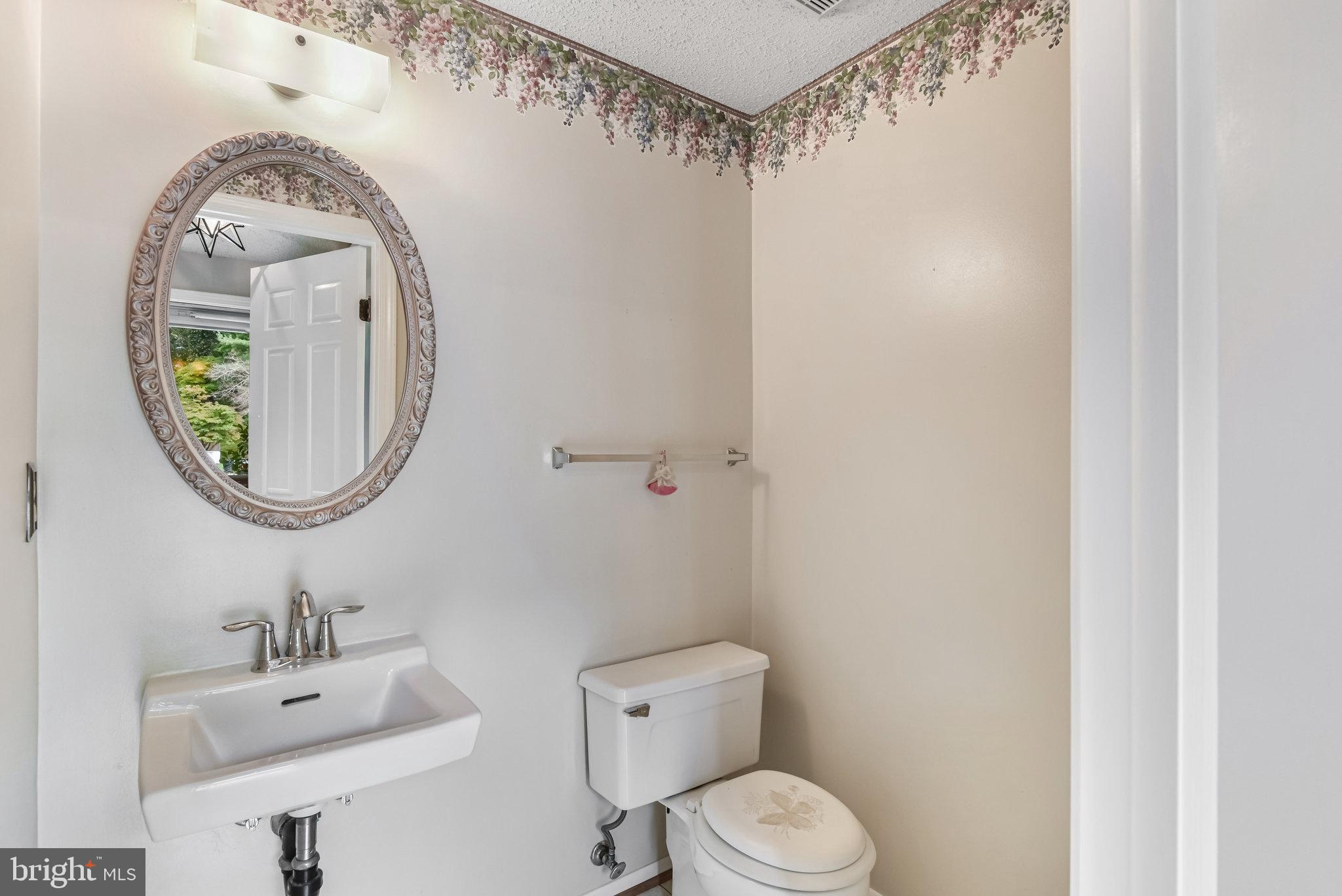 5825 High Bluff Court Burke, VA 22015 - Photo 12 of 52 a bathroom with a toilet sink vanity and mirror