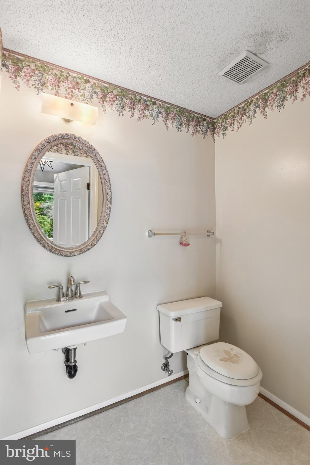 5825 High Bluff Court Burke, VA 22015 - Photo 13 of 52 a bathroom with a toilet sink vanity and mirror