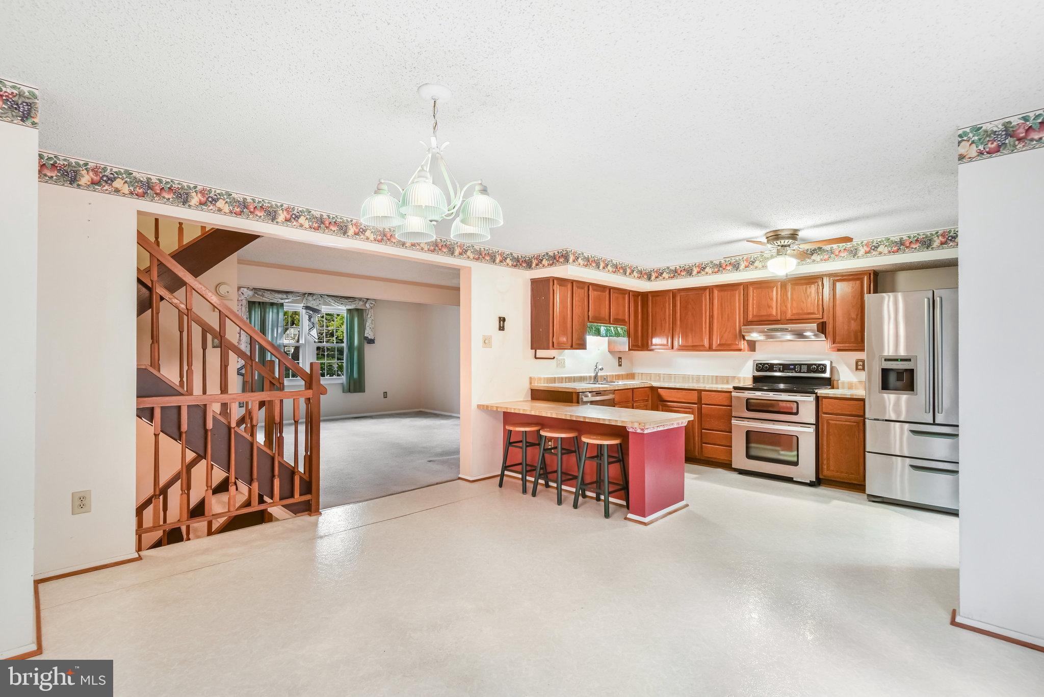 5825 High Bluff Court Burke, VA 22015 - Photo 15 of 52 a large kitchen with a large counter top appliances and cabinets