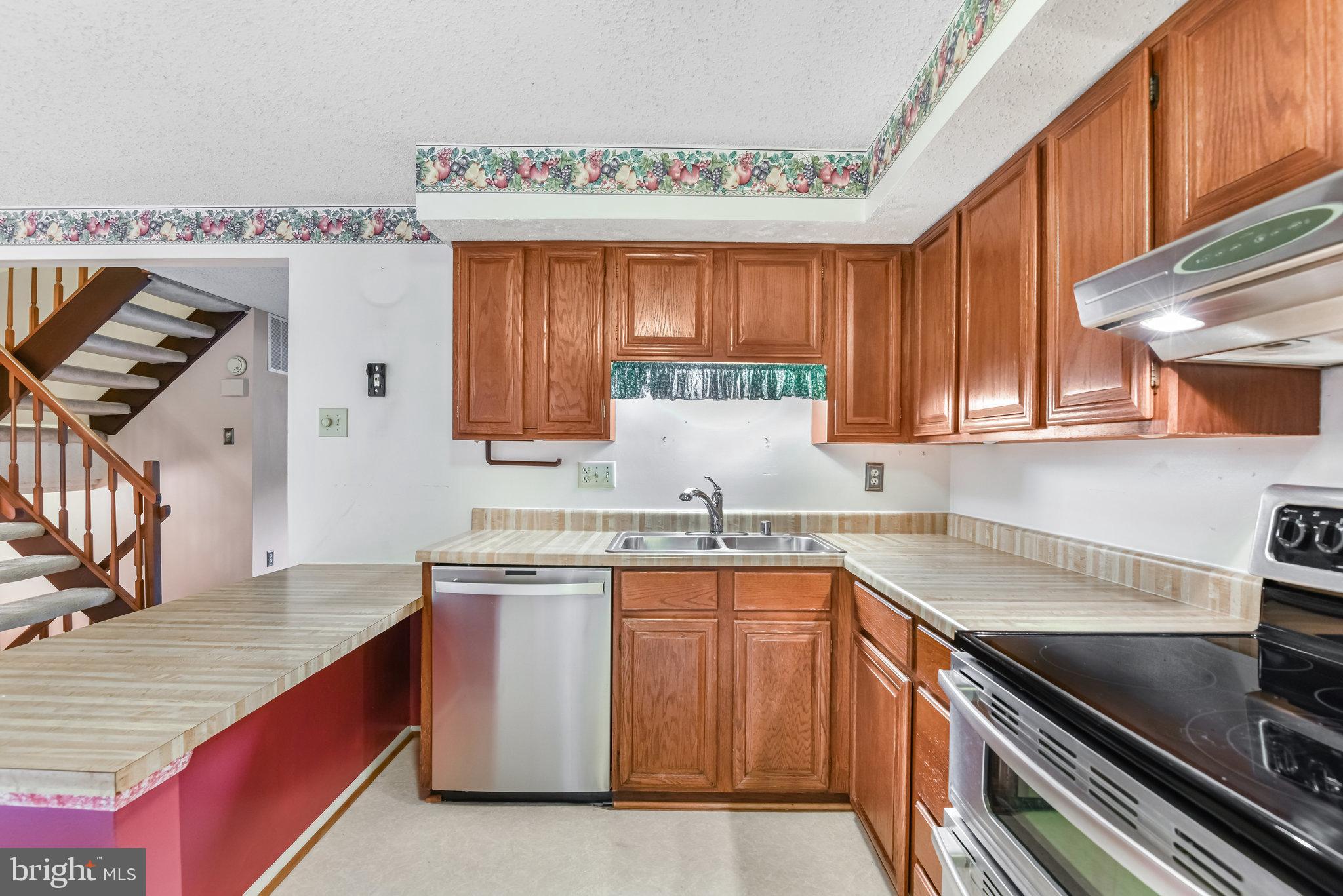 5825 High Bluff Court Burke, VA 22015 - Photo 19 of 52 a kitchen with a sink stove and cabinets