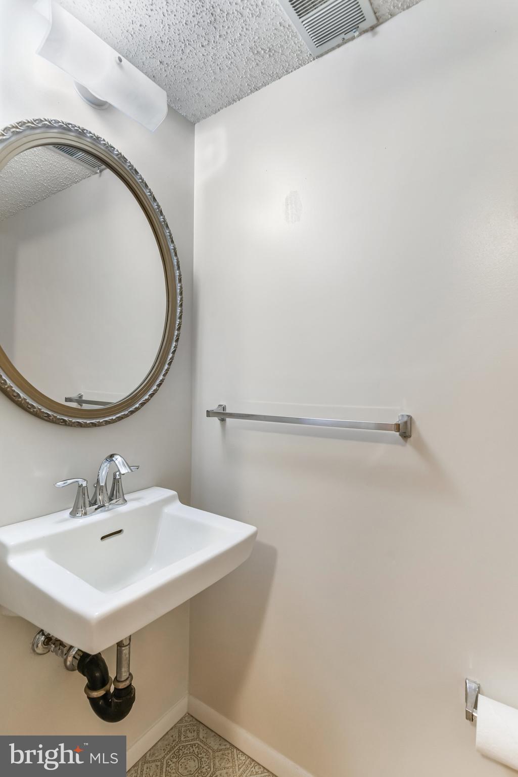 5825 High Bluff Court Burke, VA 22015 - Photo 24 of 52 a bathroom with a sink and a mirror