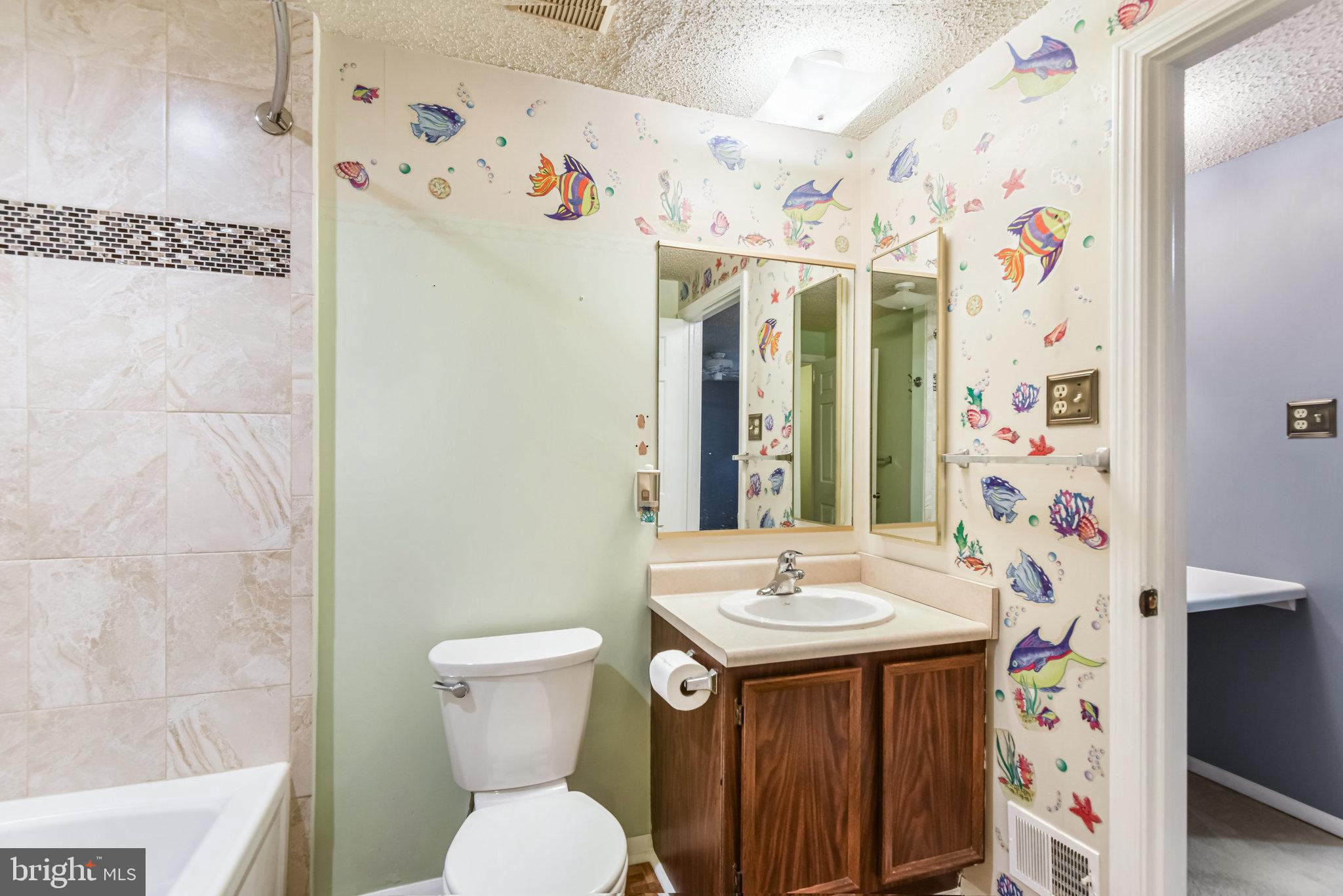 5825 High Bluff Court Burke, VA 22015 - Photo 31 of 52 a bathroom with a sink toilet and shower