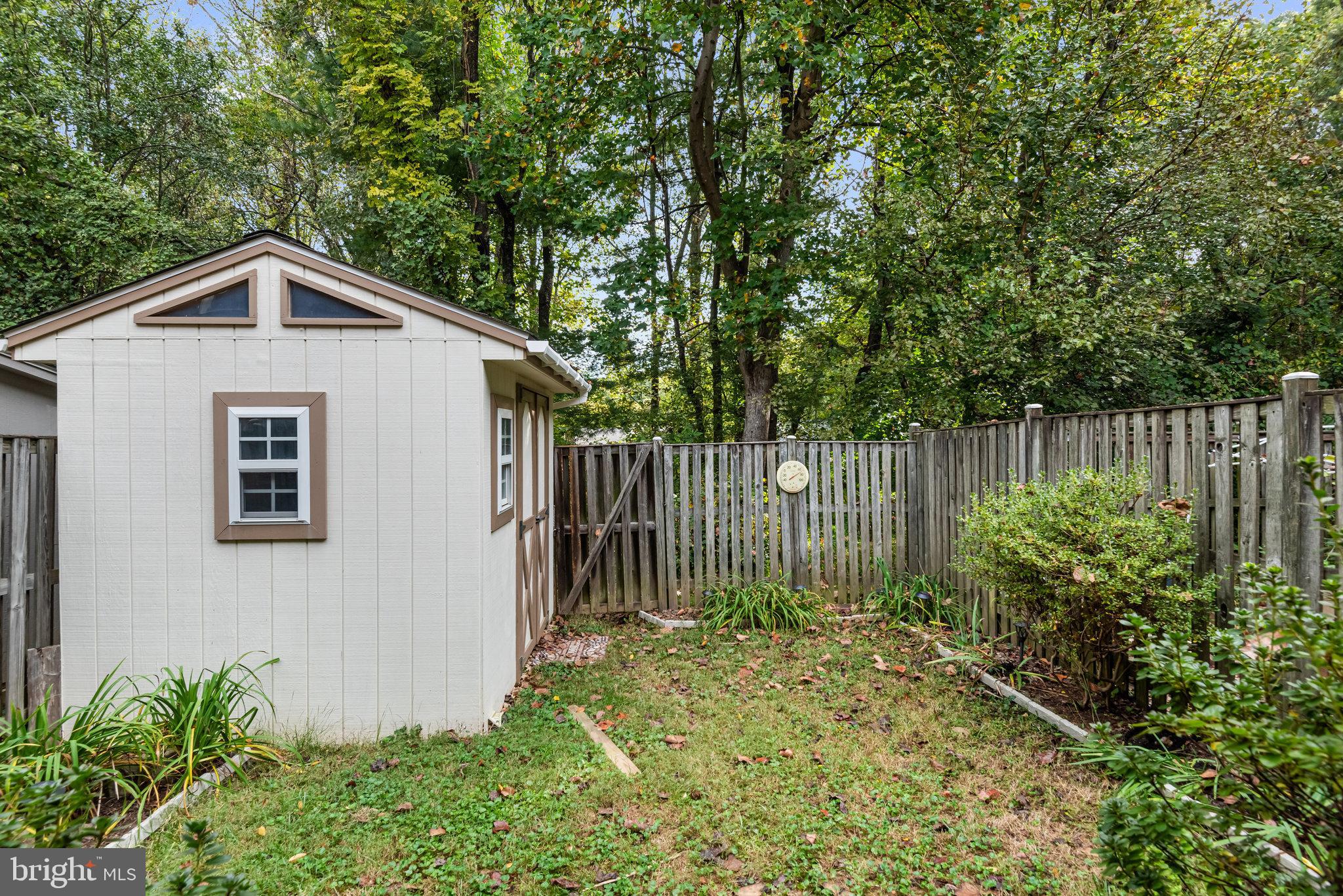 5825 High Bluff Court Burke, VA 22015 - Photo 44 of 52 a front view of a house with garden