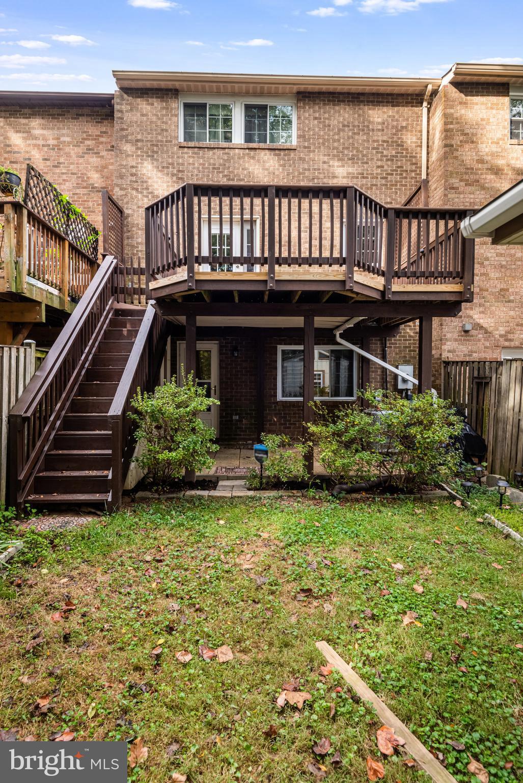 5825 High Bluff Court Burke, VA 22015 - Photo 46 of 52 a view of a house with brick walls and a small yard