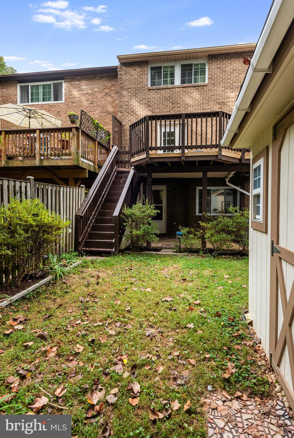5825 High Bluff Court Burke, VA 22015 - Photo 48 of 52 a view of a house with a small yard and wooden deck