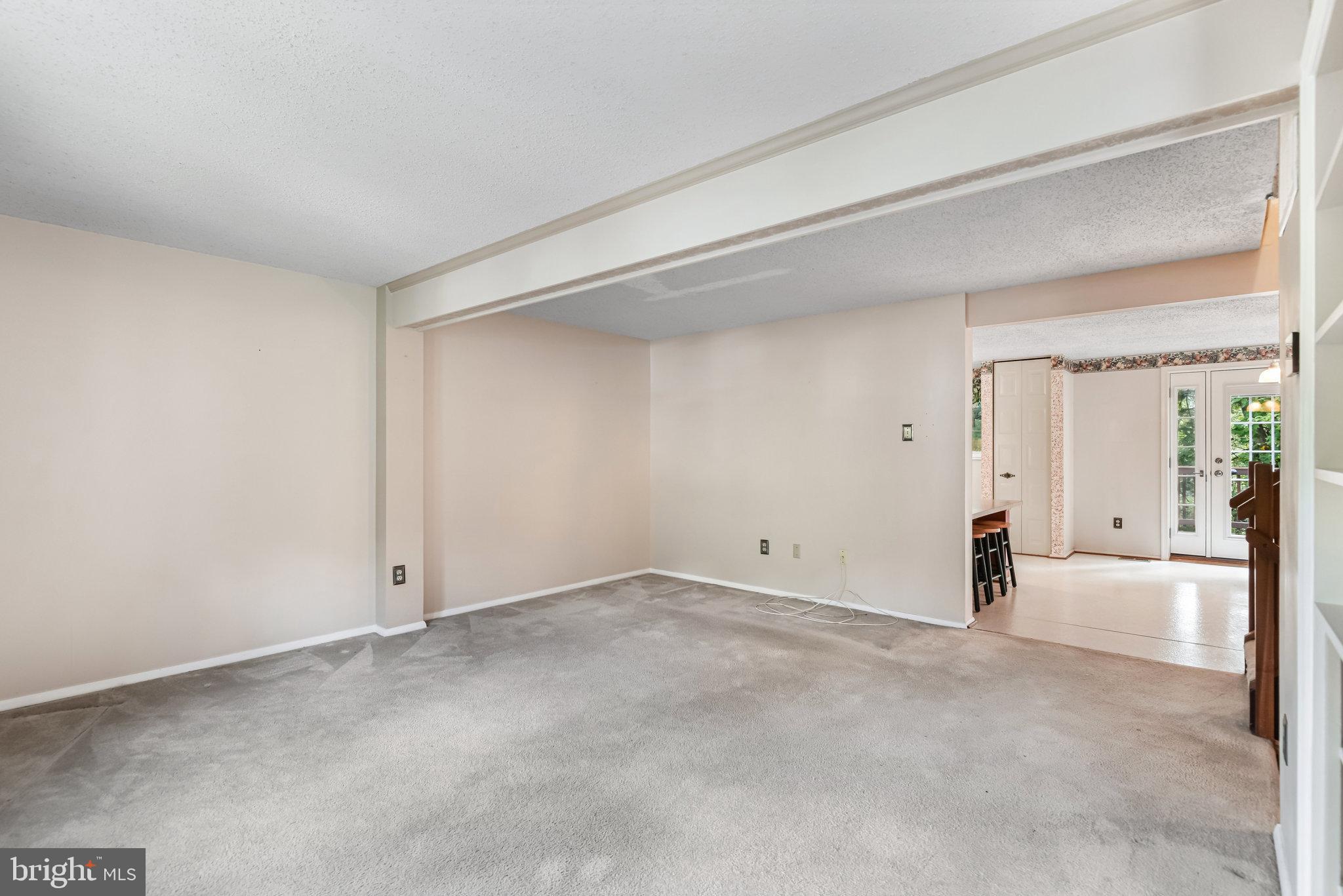 5825 High Bluff Court Burke, VA 22015 - Photo 10 of 52 a view of an empty room with wooden floor and a window