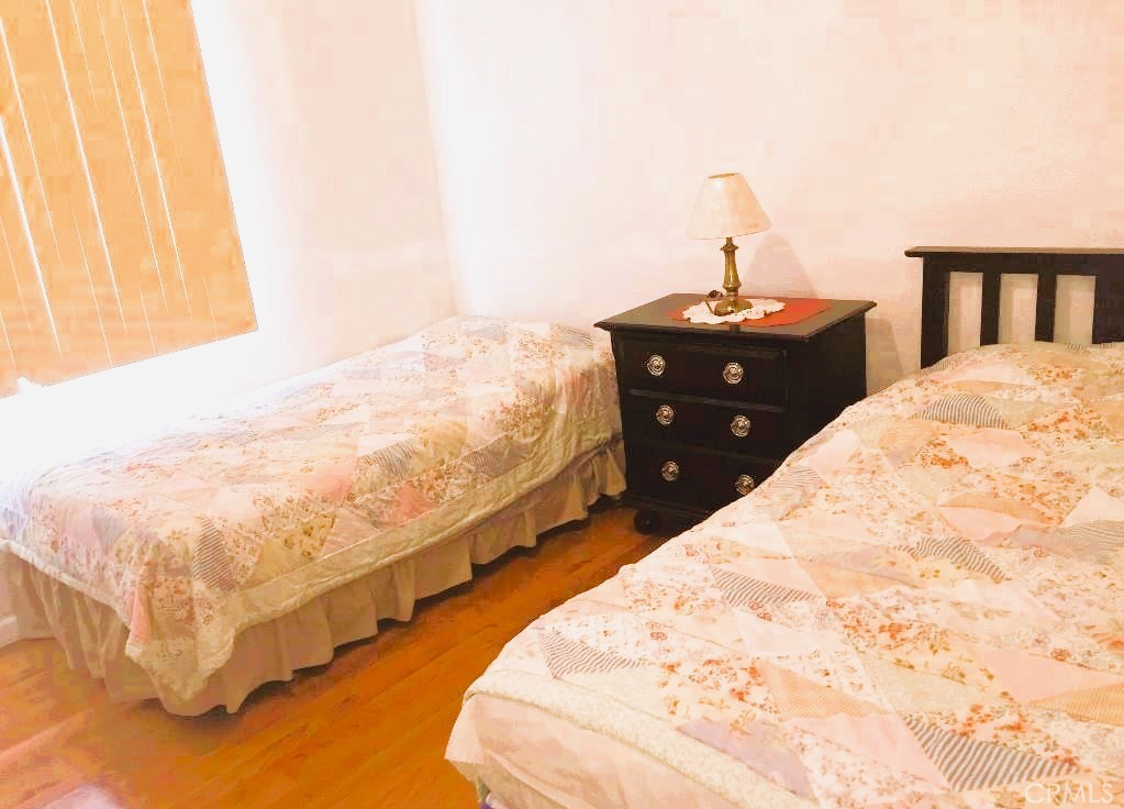 4635 Merced Avenue Baldwin Park, CA 91706 - Photo 11 of 18 a bed sitting in a bedroom next to a window