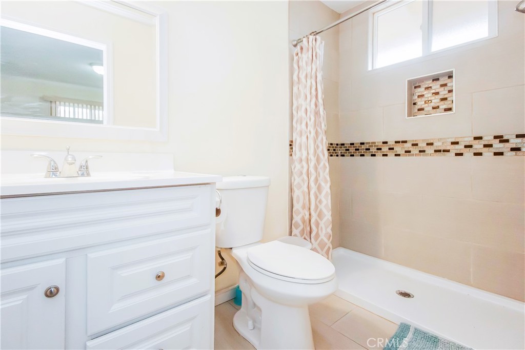 4635 Merced Avenue Baldwin Park, CA 91706 - Photo 7 of 18 a bathroom with a sink a toilet and shower