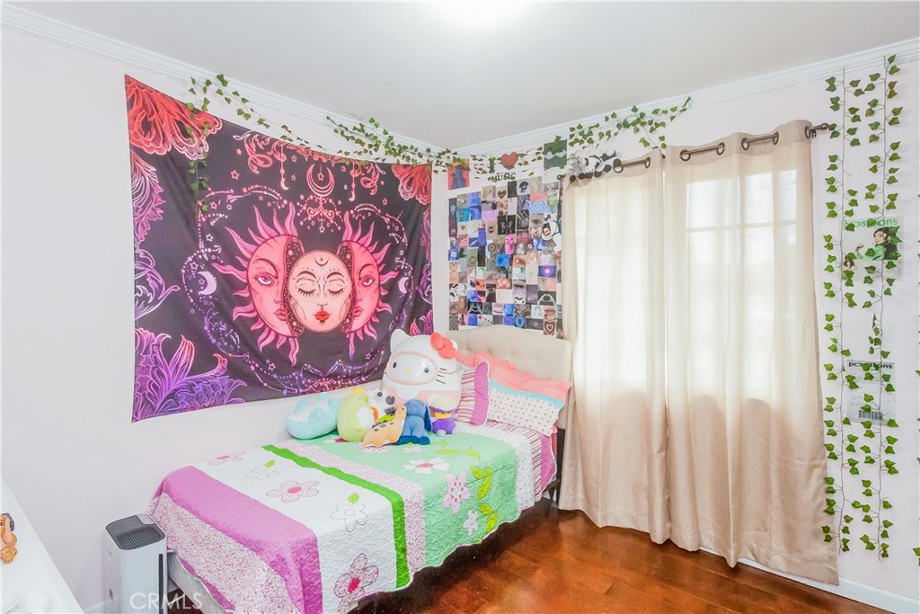 4635 Merced Avenue Baldwin Park, CA 91706 - Photo 9 of 18 a bedroom with a bed and a painting on the wall